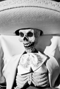 Skeleton wearing a hat. Treating death with a sense of humor to lessen it's sadness.