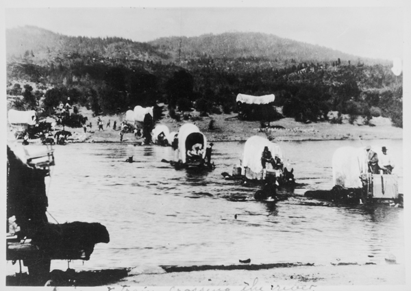 Wagon Train, crossing a river,  bringing emigrant families from the east to the new west