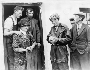 Amelia Earhart and crew are greeted by a farm family who witnessed their landing